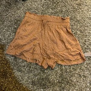 Brown shorts with white polka dots.